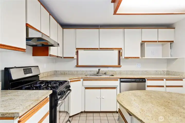4 burner gas stainless steel stove   Stainless steel dishwasher  Drop ceiling light / Tile floor  Pass through window to Family Room