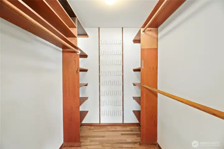 LARGE WALK IN CLOSET with built in shelves, shoe rack & bifold door entry