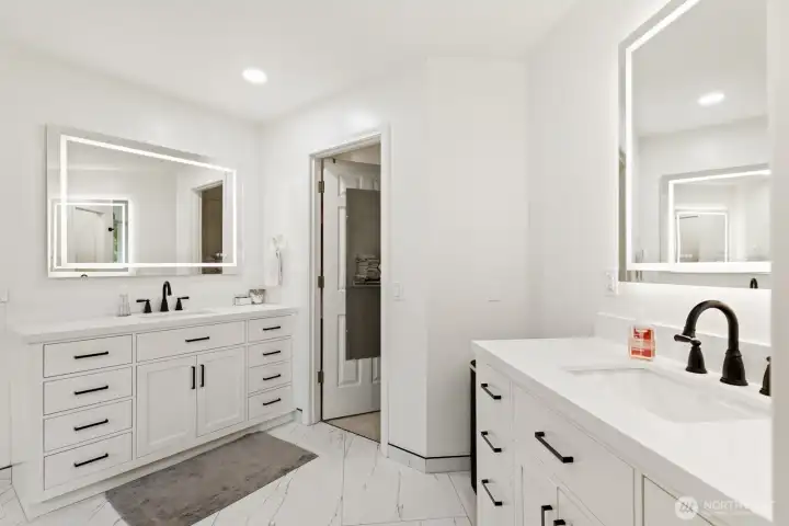 Dual quartz vanities with back lit LED mirrors.