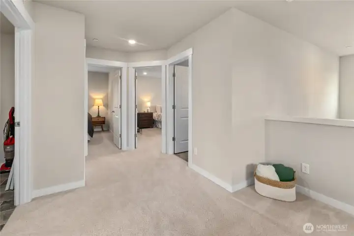 Upstairs landing looking towards two bedrooms and the full bath
