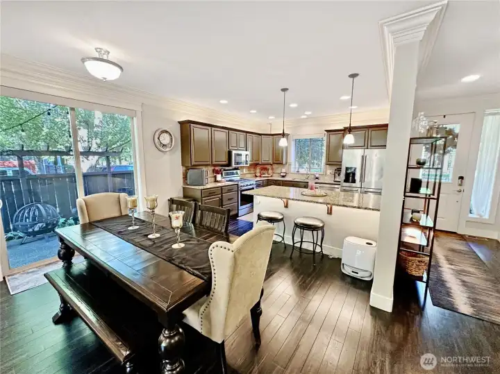 Ample dining area is open to kitchen with a large slider to access patio, perfect for BBQing. Island offers additional seating.   Entry is off to the right.