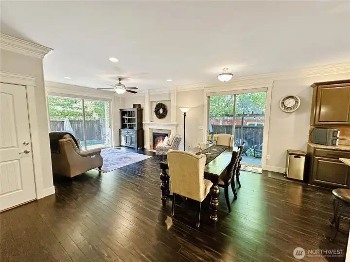 View of dining area and great room just off kitchen.  Large sliders offer access to patio oasis!! Door to garage is too the left.
