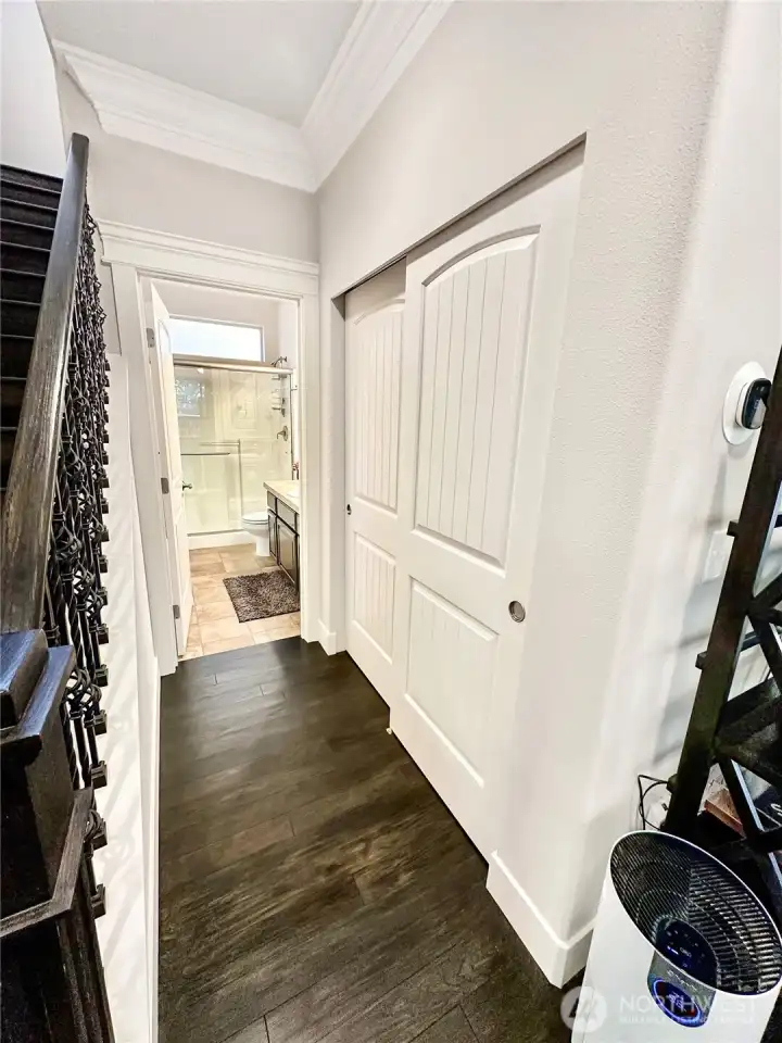 Hallway with storage leads to main floor bath.