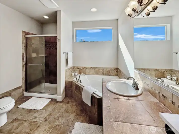 Primary bath offers soaking tub and separate shower.