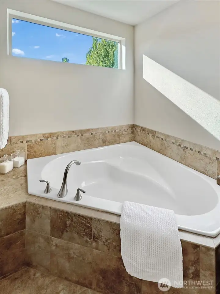 Corner tub in primary is perfect for a relaxing soak.