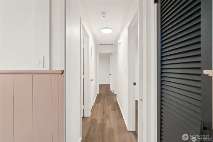 Down the hall to main full bath and 3 additional bedrooms.  This hallway has an old-fashioned pocket door! One of those sweet features from yester-year that allowed for entertaining and plenty of quiet while sleeping