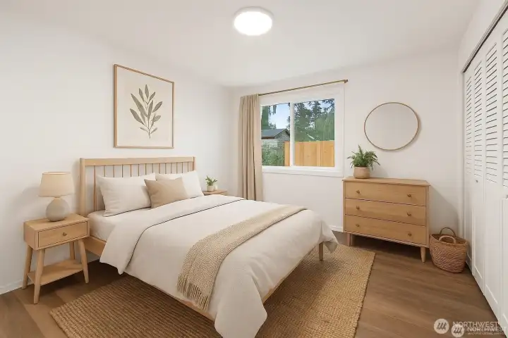 Another bedroom; also wood floors and dual closets