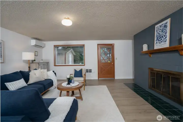 Cozy Family Room with fireplace and new mini-split. Door leads right outside