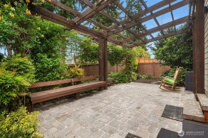 A sweeping paver patio with custom pergola set the scene for summer evenings, while mature landscaping and full fencing offer privacy. A sweeping paver patio with custom pergola set the scene for summer evenings, while mature landscaping and full fencing offer privacy.