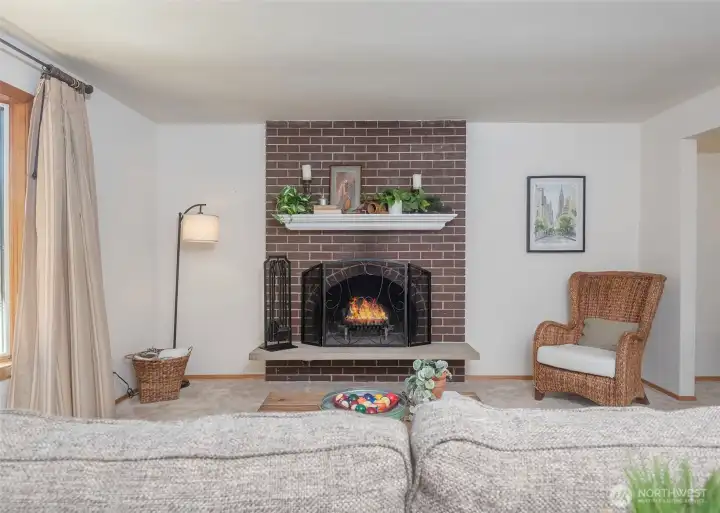 A classic wood-burning fireplace serves as the focal point of the front living room, adding warmth, character, and a cozy ambiance to the space.