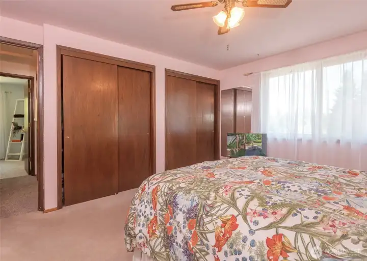 The spacious primary suite is filled with natural light, creating a bright and inviting retreat. Thoughtfully designed, it features dual closets that provide abundant storage and organization, along with a private ensuite bathroom for added comfort and convenience.