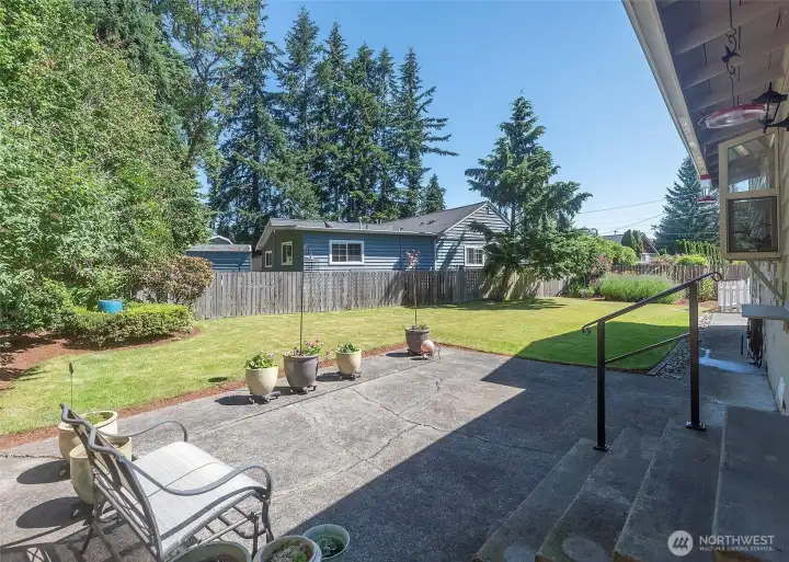 A private backyard setting is complemented by a welcoming back patio, creating a comfortable outdoor space perfect for gathering or unwinding.