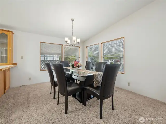 View of the dining room, love the cathedral ceilings, breakfast bar to your left and all the windows. Dining set is for sale :)