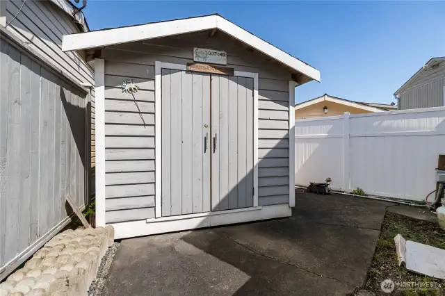 Storage shed behind trailer.