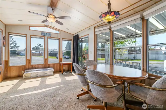Package by windows are laminated wood floors for the living rm space.