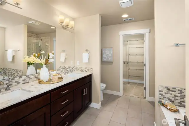 Luxurious ensuite bath features a double vanity, relaxing soaking tub and shower