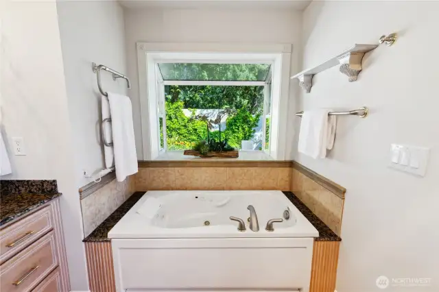 Jetted tub with garden window with greenery, flowers, birds and fountains. Soothing and relaxing.