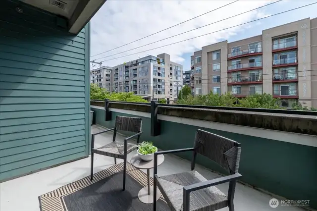 Balcony wraps around to primary bedroom window.
