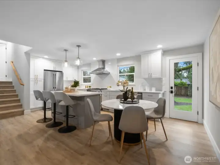 Open kitchen with eating bar and dining area