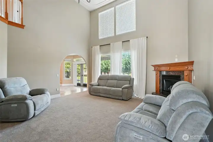 Living room with beautiful tall ceilings and cozy fireplace.