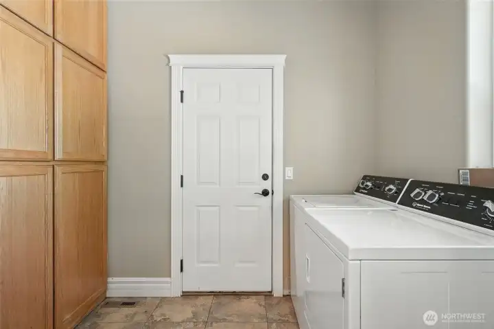 Laundry Room with more storage and door to the 3-Car Garage