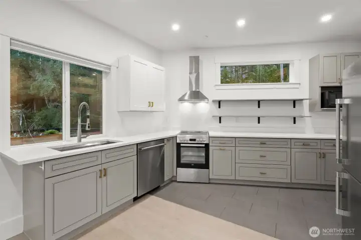 Upstairs retreat designed as a self-contained studio apartment with deck access, kitchenette, laundry, and ¾ bath—an exceptional option for multi-gen living or professional use.