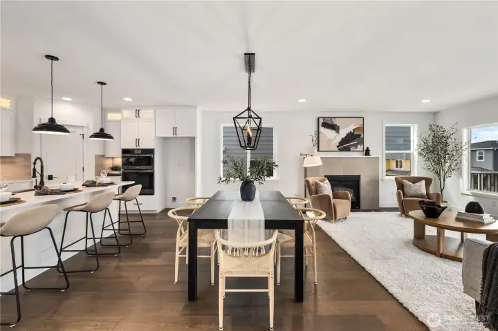 Dining Area: Central dining space with bold lighting fixture offers style and presence, easily accommodating everyday meals or formal occasions. Its placement keeps the kitchen and living area just steps away for seamless flow.  These photos are of the actual, staged home being sold at Foxmoore. However, all photos, renderings, site maps, and floorplans are for visualization purposes only. Plans, colors, building orientation, finishes, home outlook, and other details can and WILL vary.