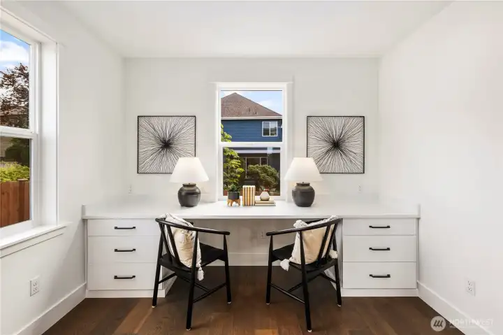 Main Level Pocket Office Nook: Built-in desk with dual workspaces and drawers sits perfectly by bright windows, offering a quiet spot for productivity or creativity. Its central location keeps it connected to the main living areas while maintaining a sense of retreat.  These photos are of the actual, staged home being sold at Foxmoore. However, all photos, renderings, site maps, and floorplans are for visualization purposes only. Plans, colors, building orientation, finishes, home outlook, and other details can and WILL vary.