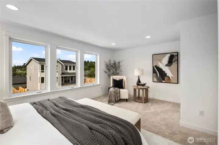 Primary Bedroom: A serene space with expansive windows capturing neighborhood views and warm natural light. Comfortable proportions create an inviting sanctuary. These photos are of the actual, staged home being sold at Foxmoore. However, all photos, renderings, site maps, and floorplans are for visualization purposes only. Plans, colors, building orientation, finishes, home outlook, and other details can and WILL vary.