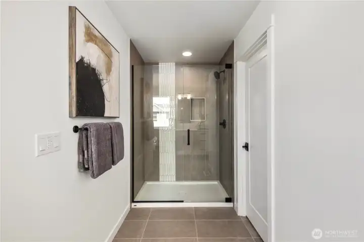 Primary Bathroom Shower: Large walk-in shower with full-height tile surround and sleek glass enclosure. Thoughtful details create a clean, modern space. These photos are of the actual, staged home being sold at Foxmoore. However, all photos, renderings, site maps, and floorplans are for visualization purposes only. Plans, colors, building orientation, finishes, home outlook, and other details can and WILL vary.
