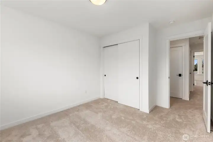 Upper Bedroom (alternate angle): Secondary bedroom with ample closet storage and easy access to the upstairs hall bath. A blank canvas for any lifestyle.  These photos are of the actual, staged home being sold at Foxmoore. However, all photos, renderings, site maps, and floorplans are for visualization purposes only. Plans, colors, building orientation, finishes, home outlook, and other details can and WILL vary.