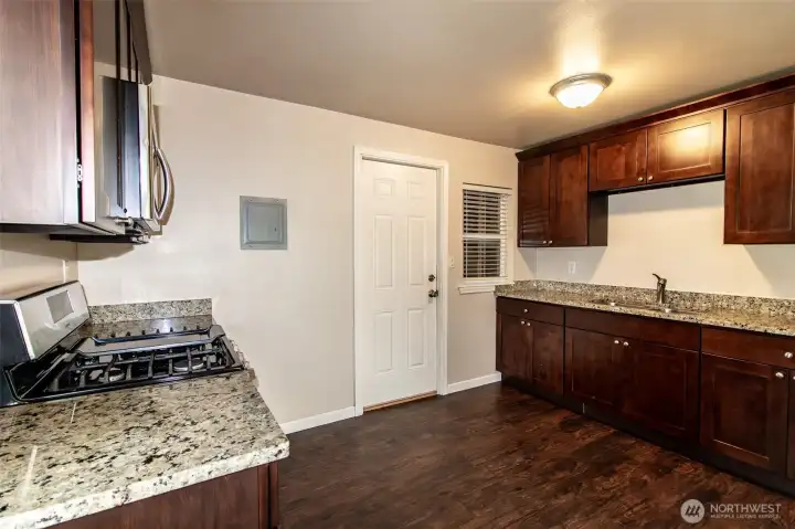 Kitchen in Unit B - door leads to utility room and rear access