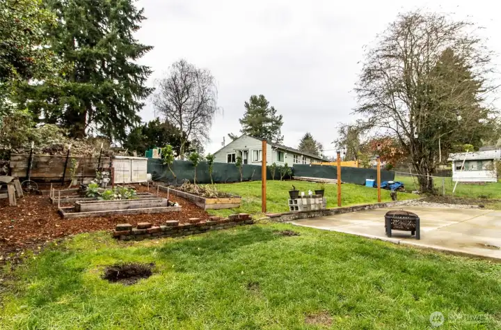 Spacious yard area with patio and garden space