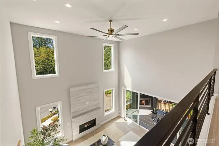 Walkway on upper floor looking down to main floor living room