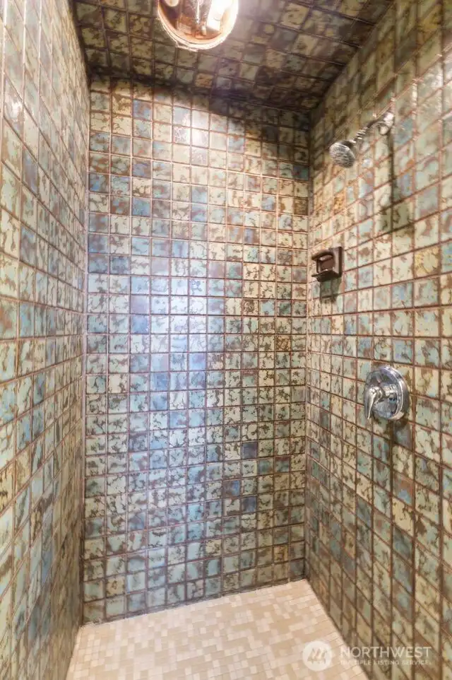 View of the tiled primary bathroom.