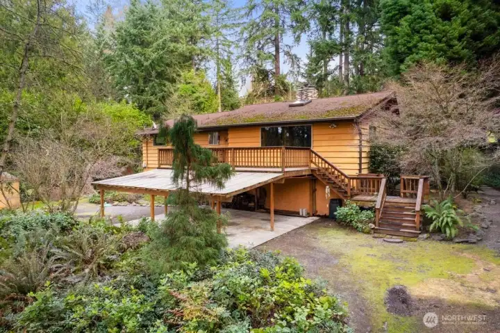 Enjoy the peaceful setting with a circular drive and carport, large storage shed, front deck, and a gorgeous backyard patio with firepit, all surrounded by mature landscaping and towering trees that provide exceptional privacy.