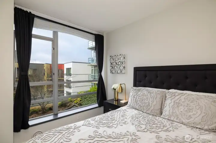 Bedroom has view of patio area.