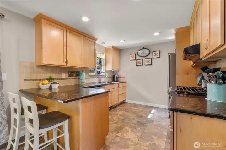 Updated maple cabinets in kitchen with Whirlpool appliances.