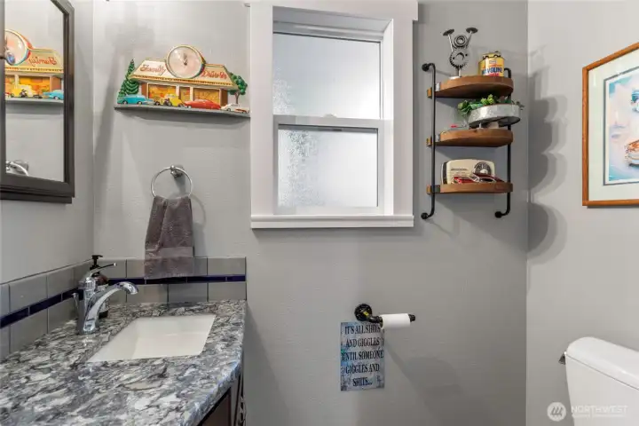 Half bath conveniently located off garage/pantry/laundry area.