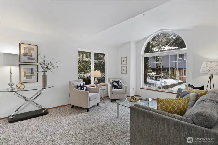 The light, bright, living room w/ vaulted window is immediately to your right as you come in