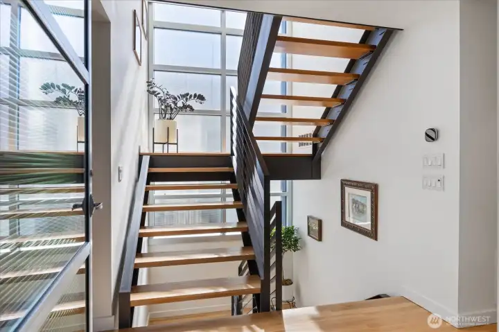 Floating staircase with floor to ceiling windows