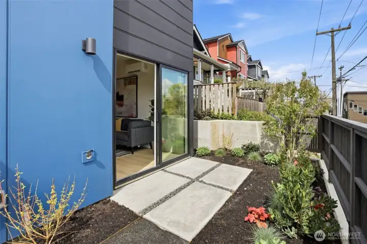 Private fenced patio with low-maintenance landscaping, garden space, and room for outdoor dining, entertaining, or pets.