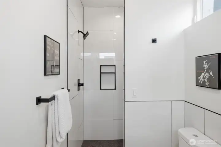 Large walk-in shower with custom, comtemporary tile work.