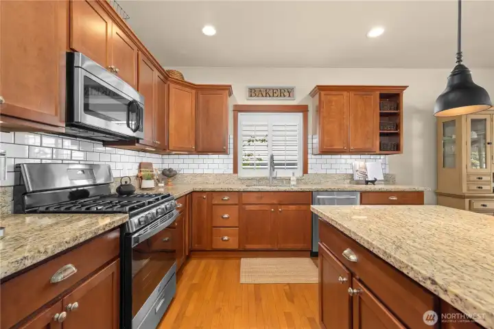 Solid countertops and plenty of storage. Don't miss the new range.
