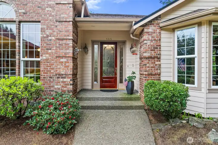Beautiful front door - covered porch shelters your guests from our WA weather.