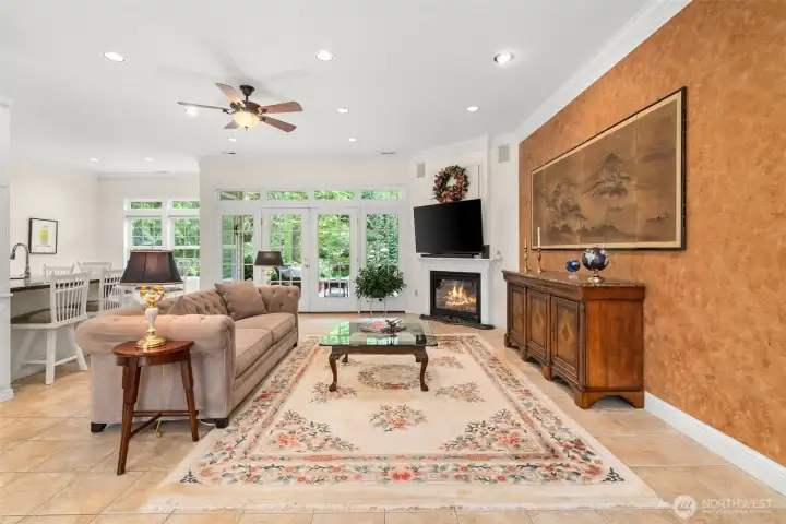 Great room has cozy gas fireplace and surround sound, even a cabinet behind the wreath to hide accessory electronics.