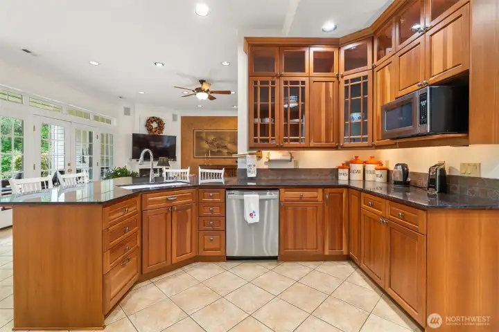 Kitchen features high-end cherry cabinets with pull-outs. Glass front cabinets have interior lighting - under cabinet lighting, too!