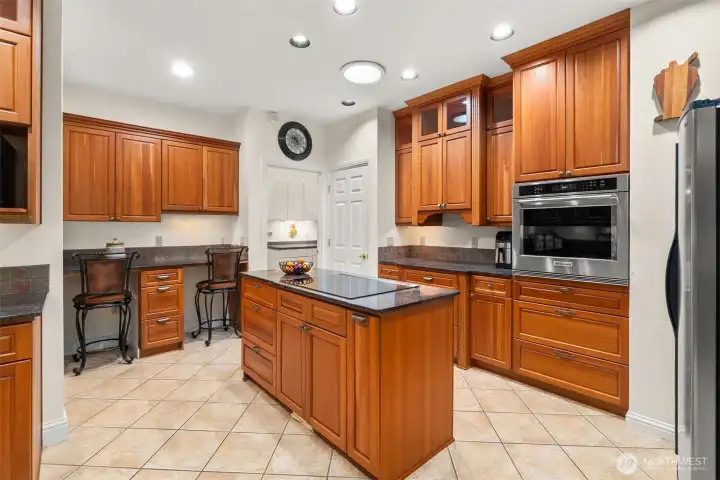 A cook's island, baking zone, stainless appliances and SO much storage!