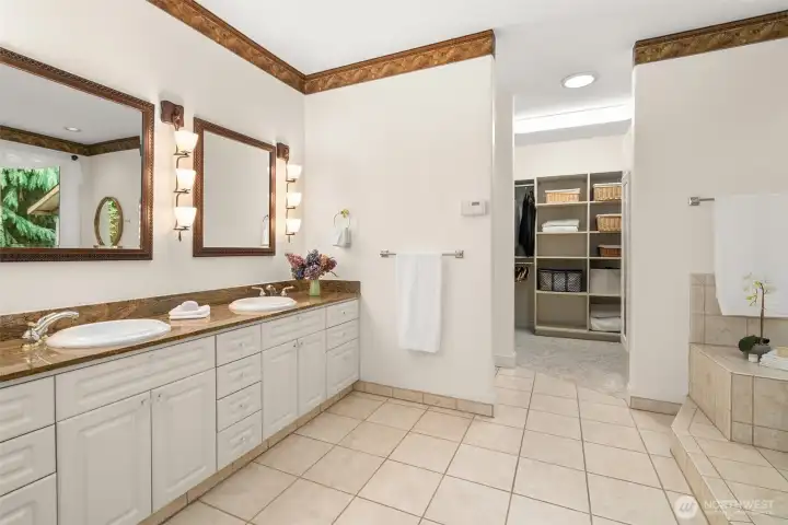 Spacious primary bath features double sinks and granite counters.