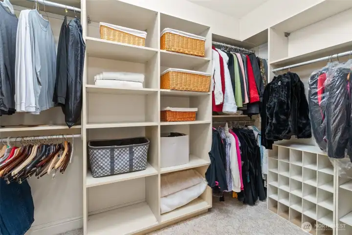 One end of the large walk-in closet with built-in storage organization.